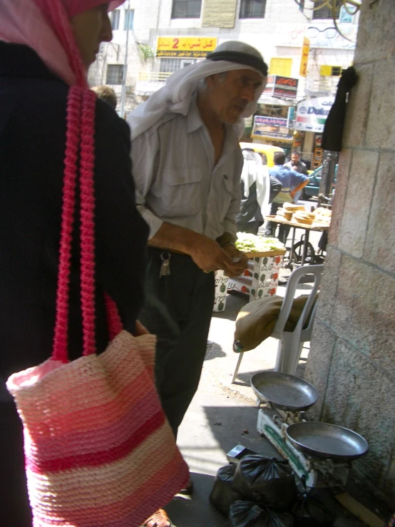 a woman and a man standing in front of a store