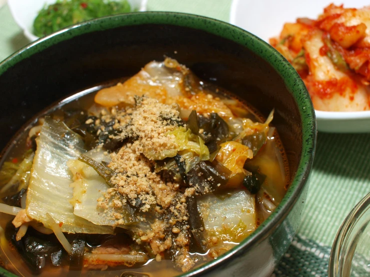 a bowl of stew with meat in it on a table