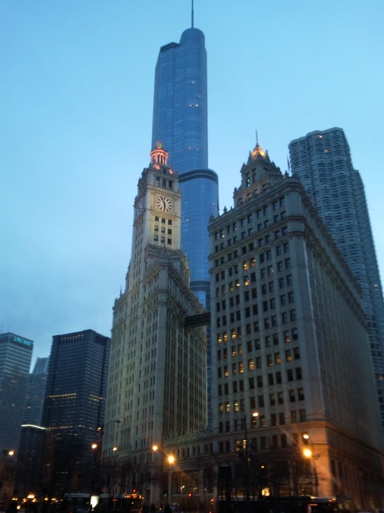 the lights shine on the skyscrs as cars drive by