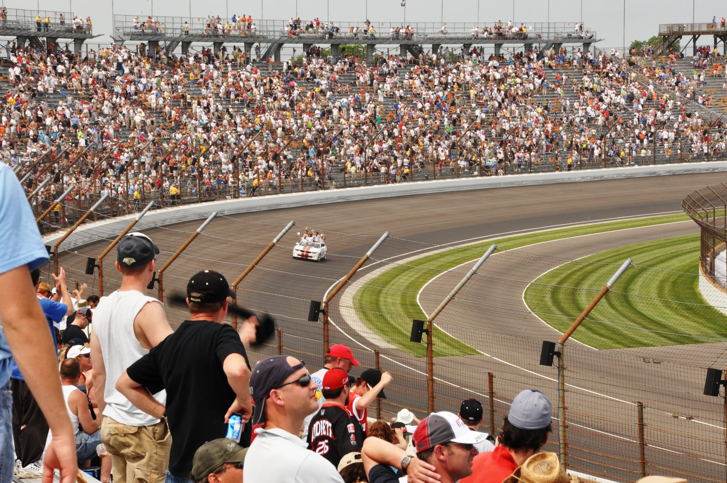 a group of people are sitting around a race track