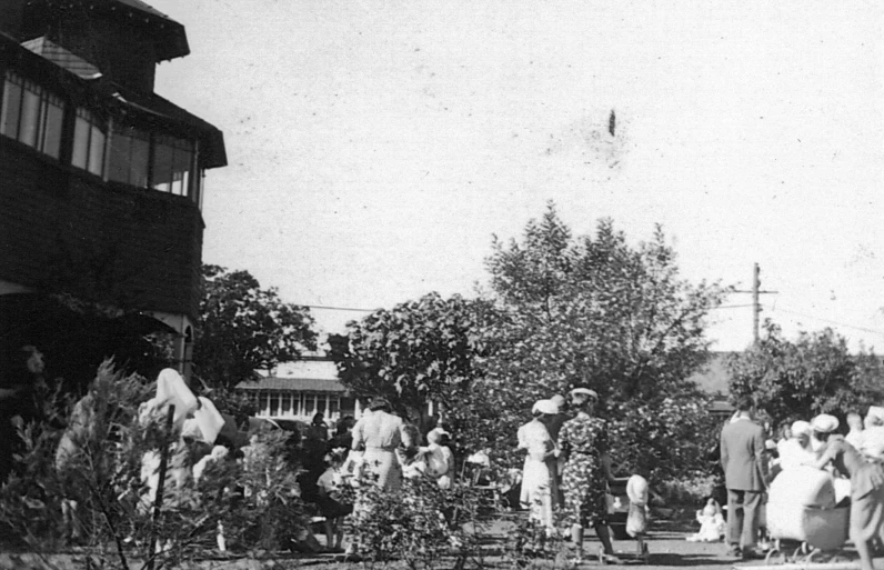 a group of people in hats and dresses are gathered around