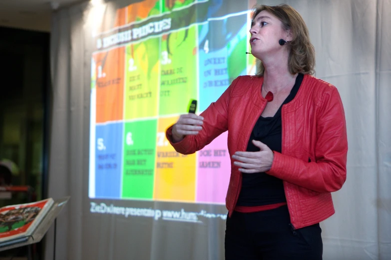 woman at a podium talking about various components of the text on a screen