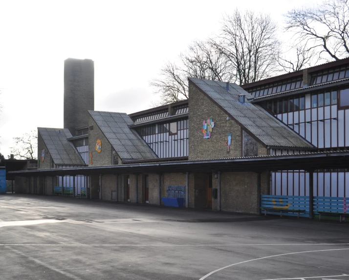 a large building with a few chimneys that are shaped like two buildings