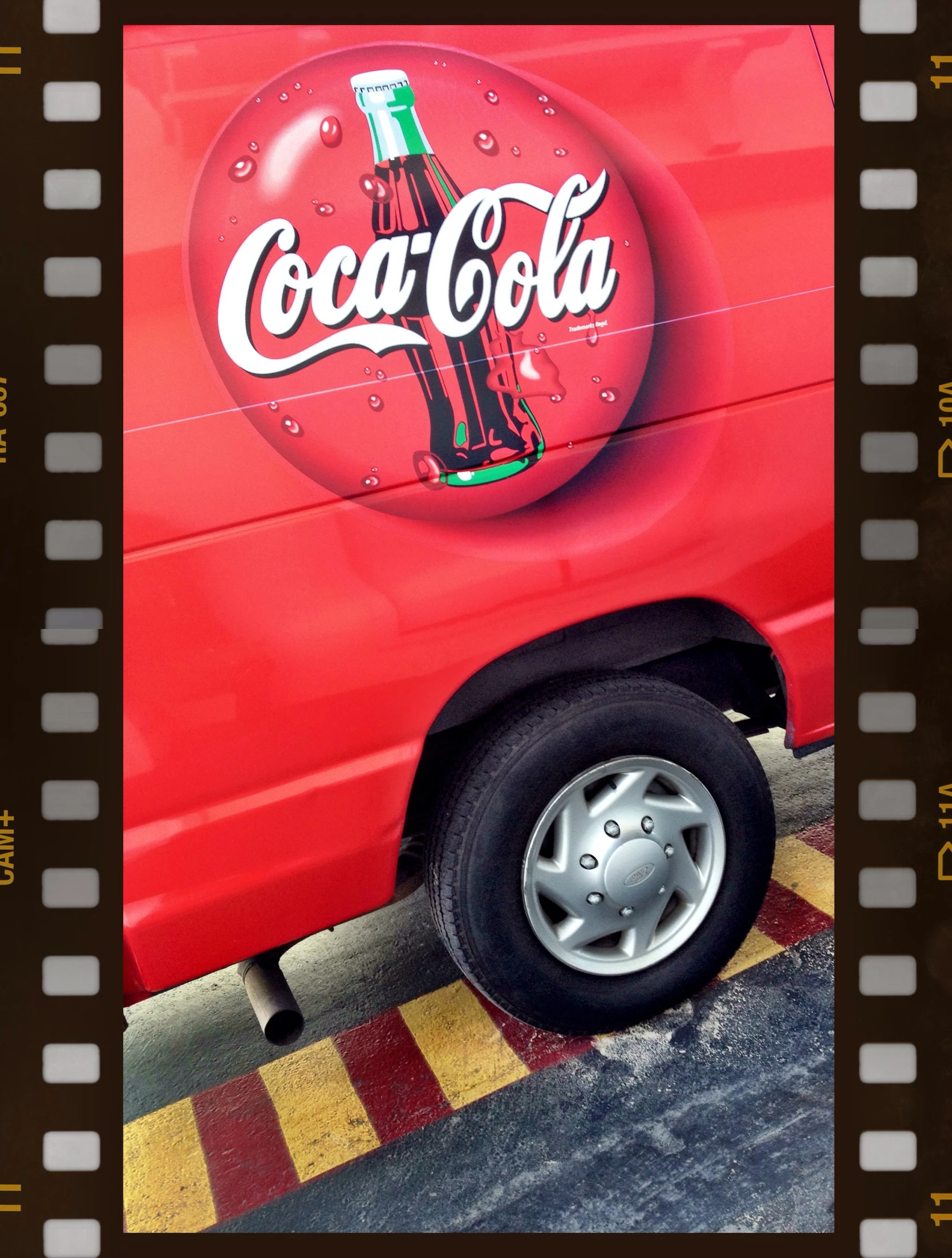 a pograph taken of an old red truck with some coke bottle's painted on the side