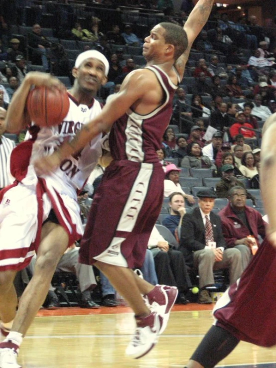 a couple of men playing a game of basketball