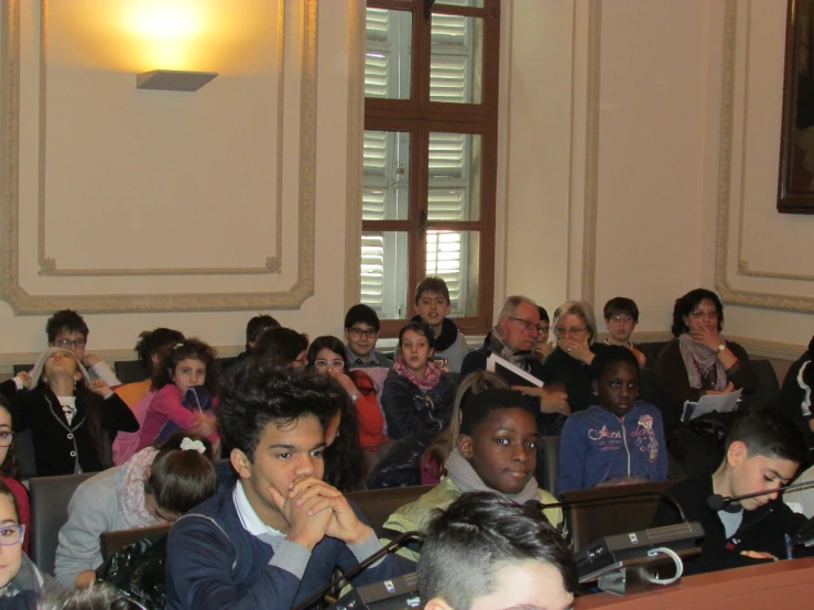 a number of people in a room with microphones