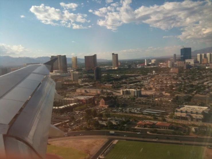 view from an airplane wing to city skyline