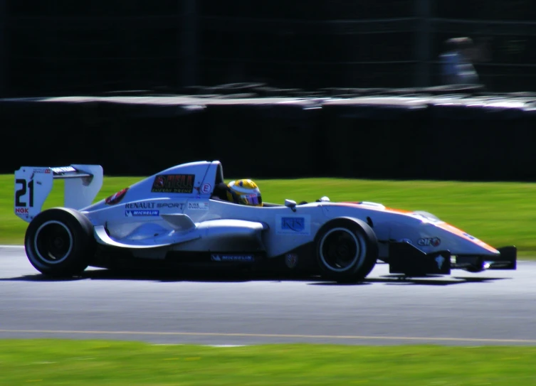 a person driving in a racing car on the race track