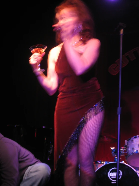 a woman in a tight red dress drinking soing