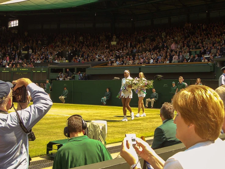 a tennis player is taking pictures at a match