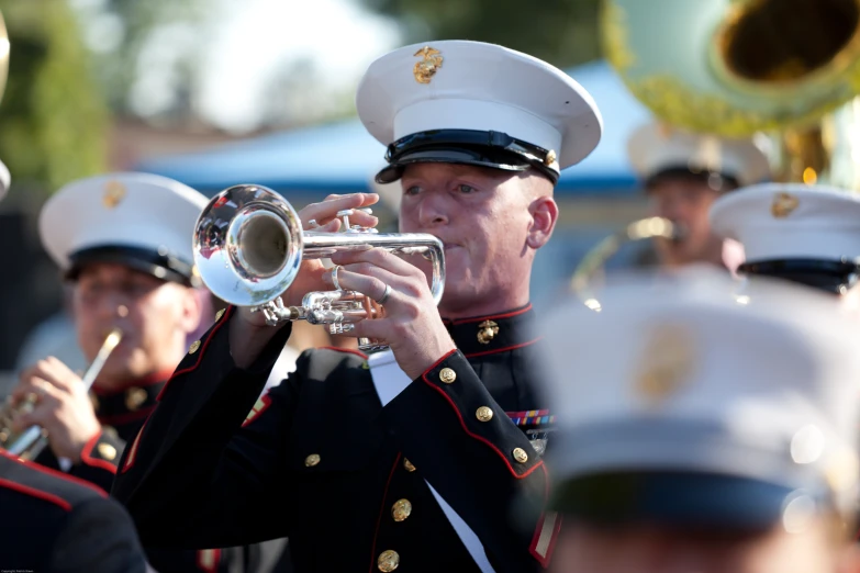 a man in military dress clothes playing the trumpet