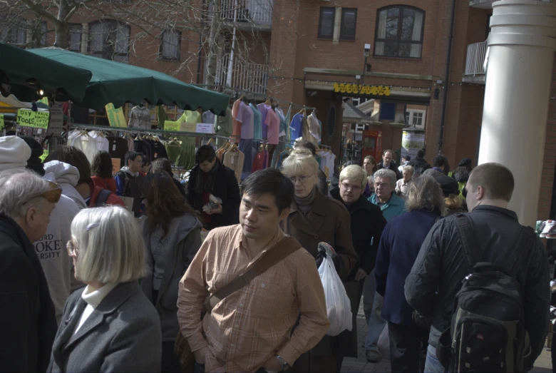 a crowded city street filled with pedestrians and shoppers