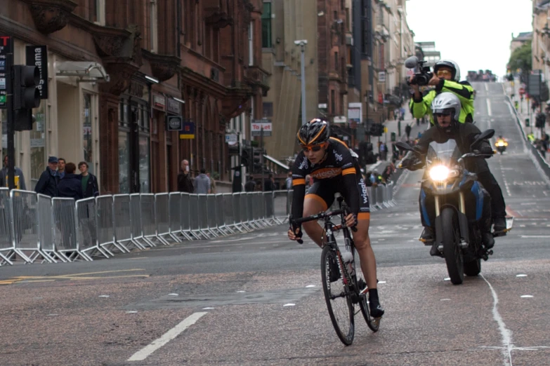 some bikers are riding on the street with other bikes