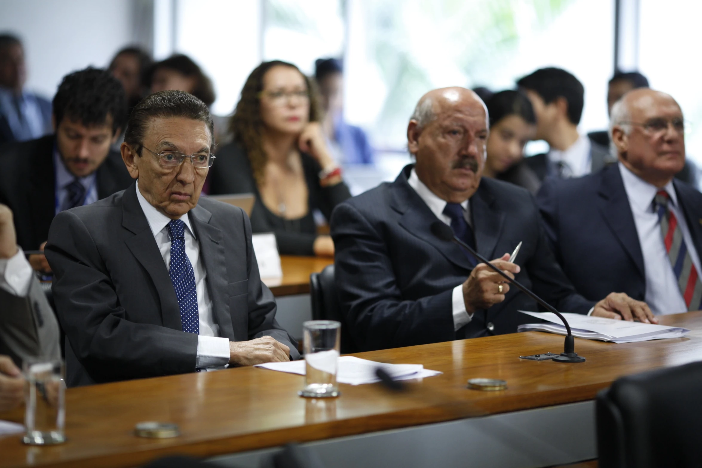 men sitting in front of people watching one another