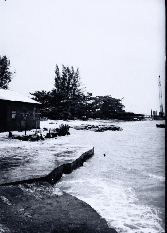 some houses sitting on the side of a body of water