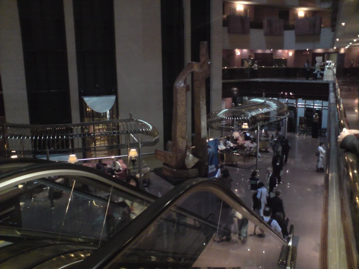 an escalator with people standing at the top