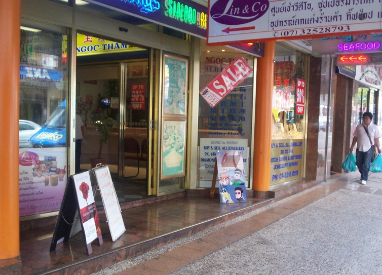 two shops with asian signage in front of them