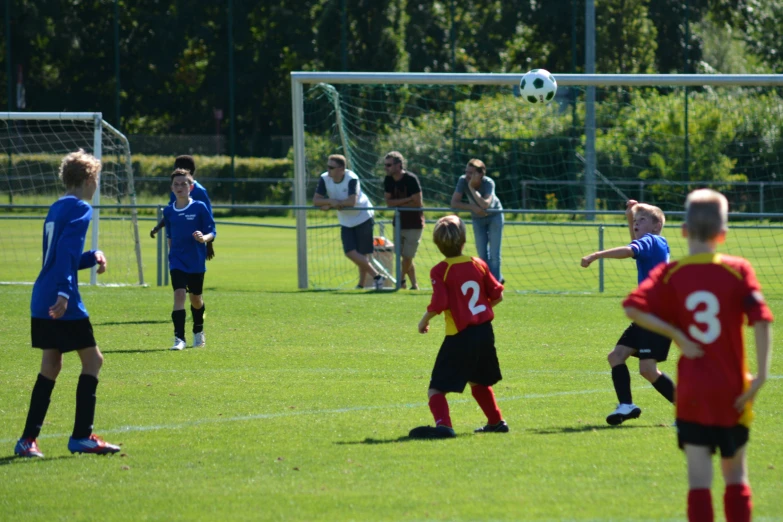 a couple of soccer players in red and black uniforms