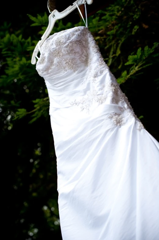 a close up of a wedding dress with an adjustable clip