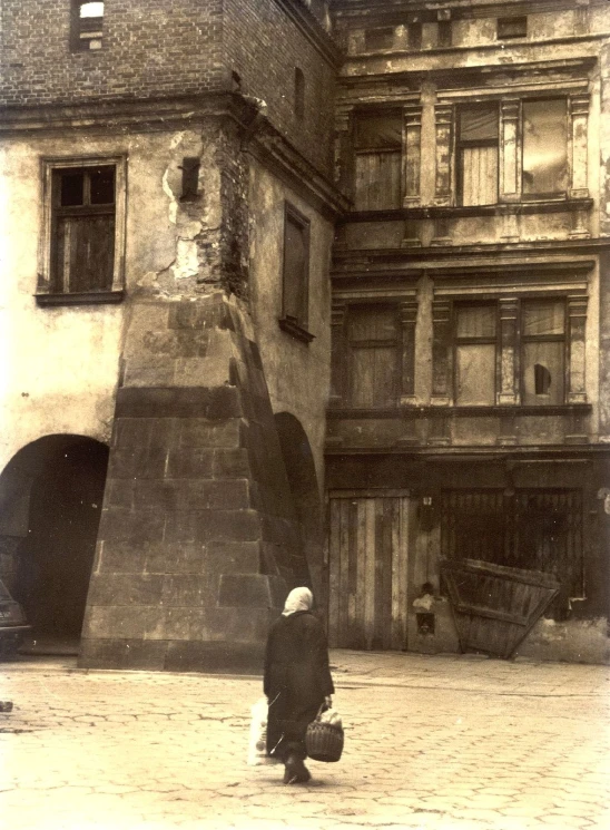 a person standing near a building with an umbrella