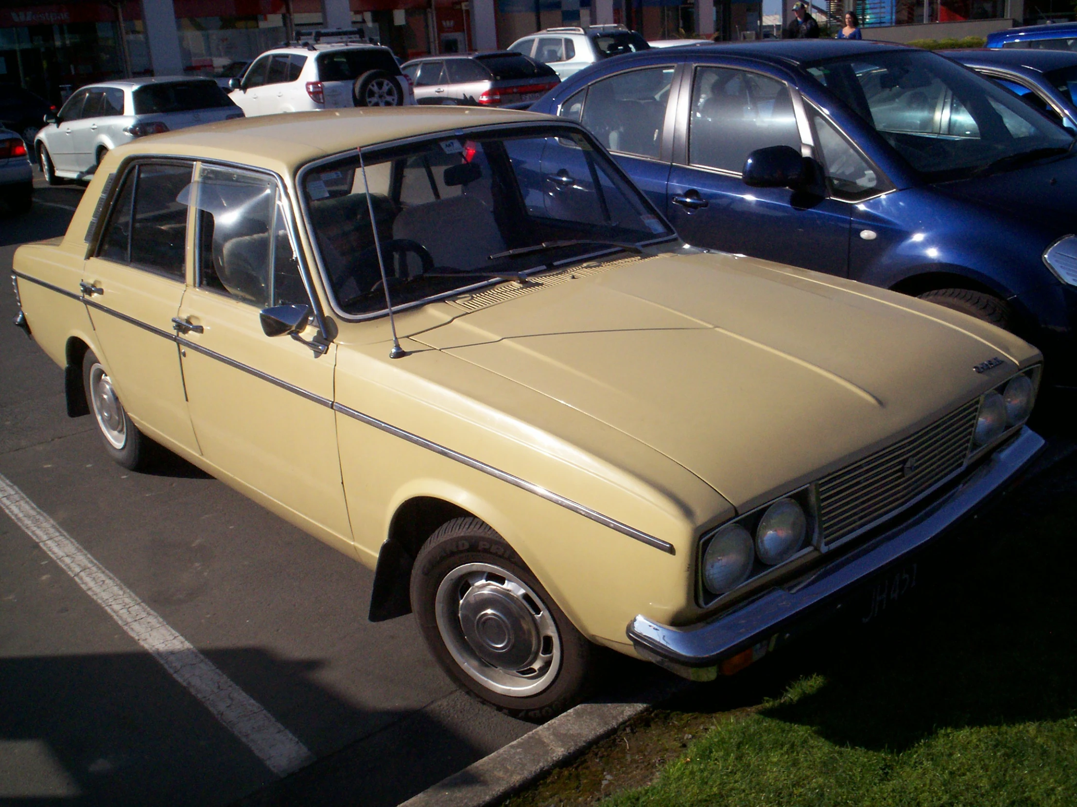 an old ford is parked in a car park