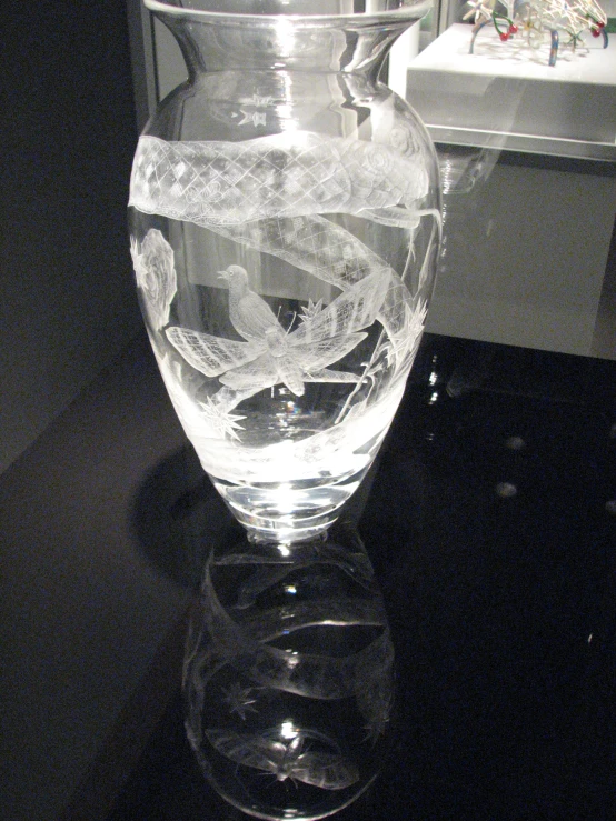 a glass vase filled with water on top of a table