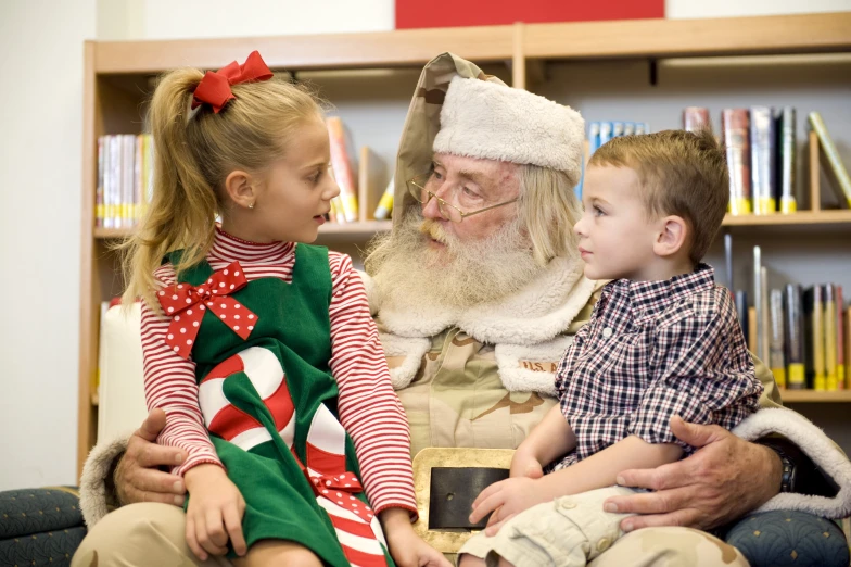 a small girl and a santa claus are talking