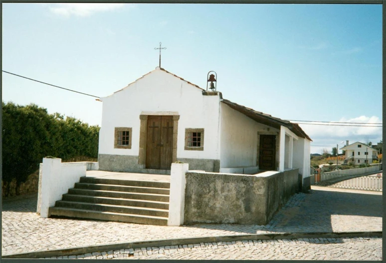 small white building with steeples and stairs