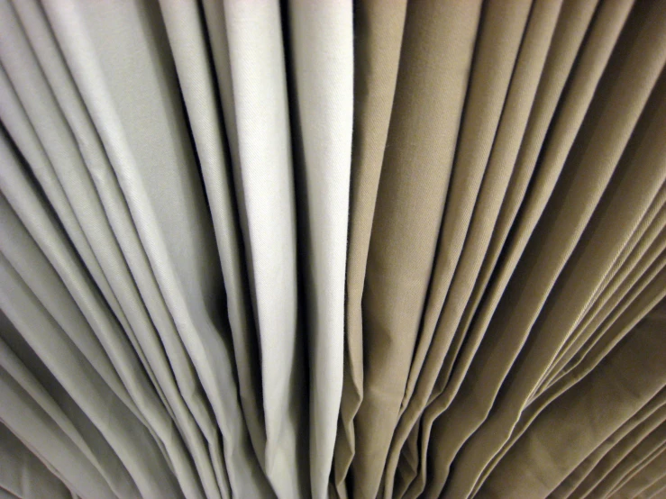 folded white paper on table with small wooden object