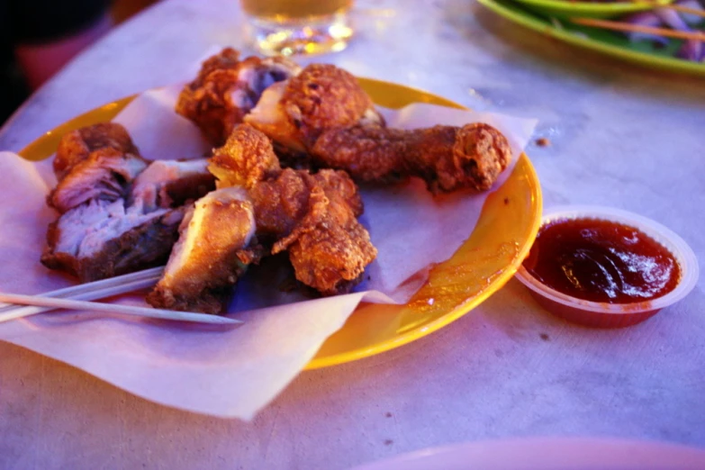 a yellow plate with some food on it