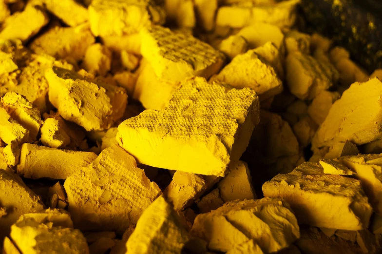 several blocks of yellow cement in a pile