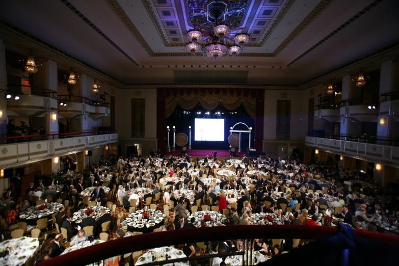 a large group of people at a dinner in a room