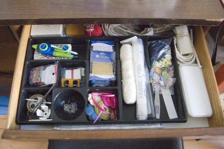 there are many things inside of this desk drawer