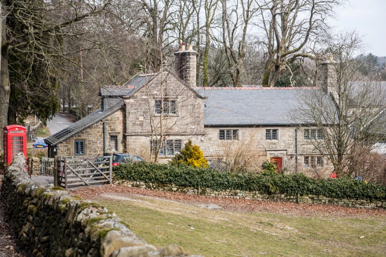 old stone building in the distance with trees in front