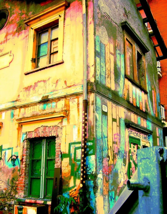 a green door and window in a dirty building