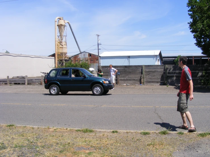 two people are standing on the sidewalk in front of a truck