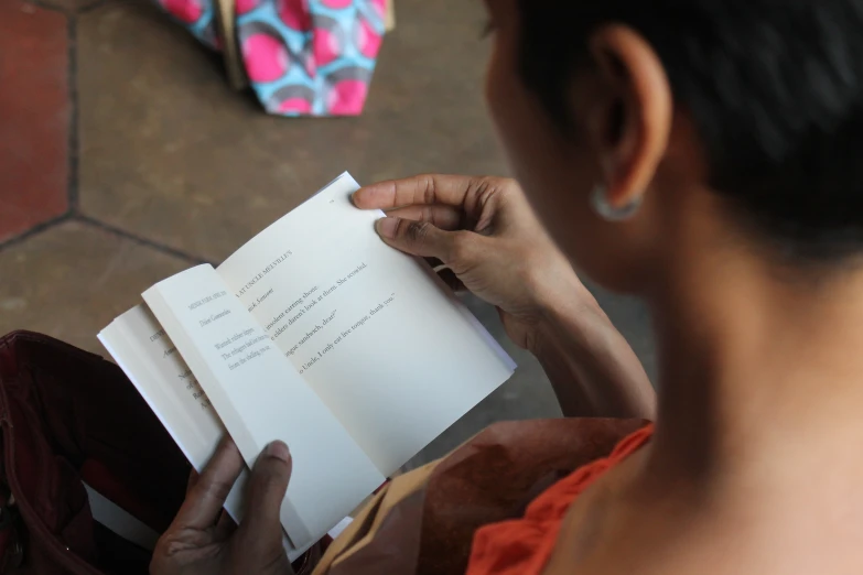 a woman reading a book that says love notes