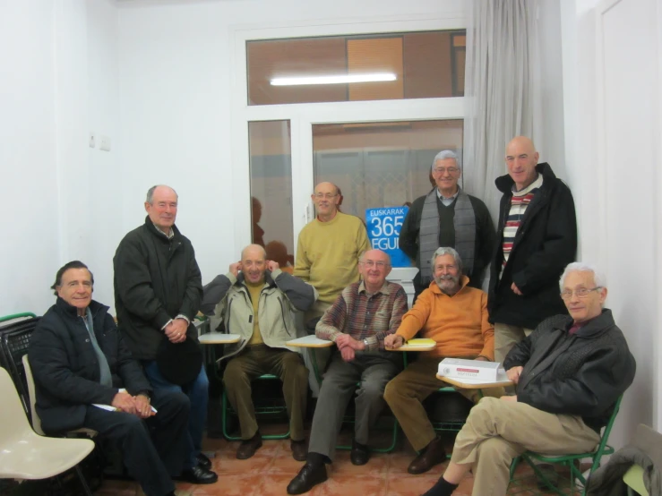 a group of people seated in chairs posing for a picture