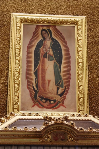 picture with golden framing of painting of the virgin mary