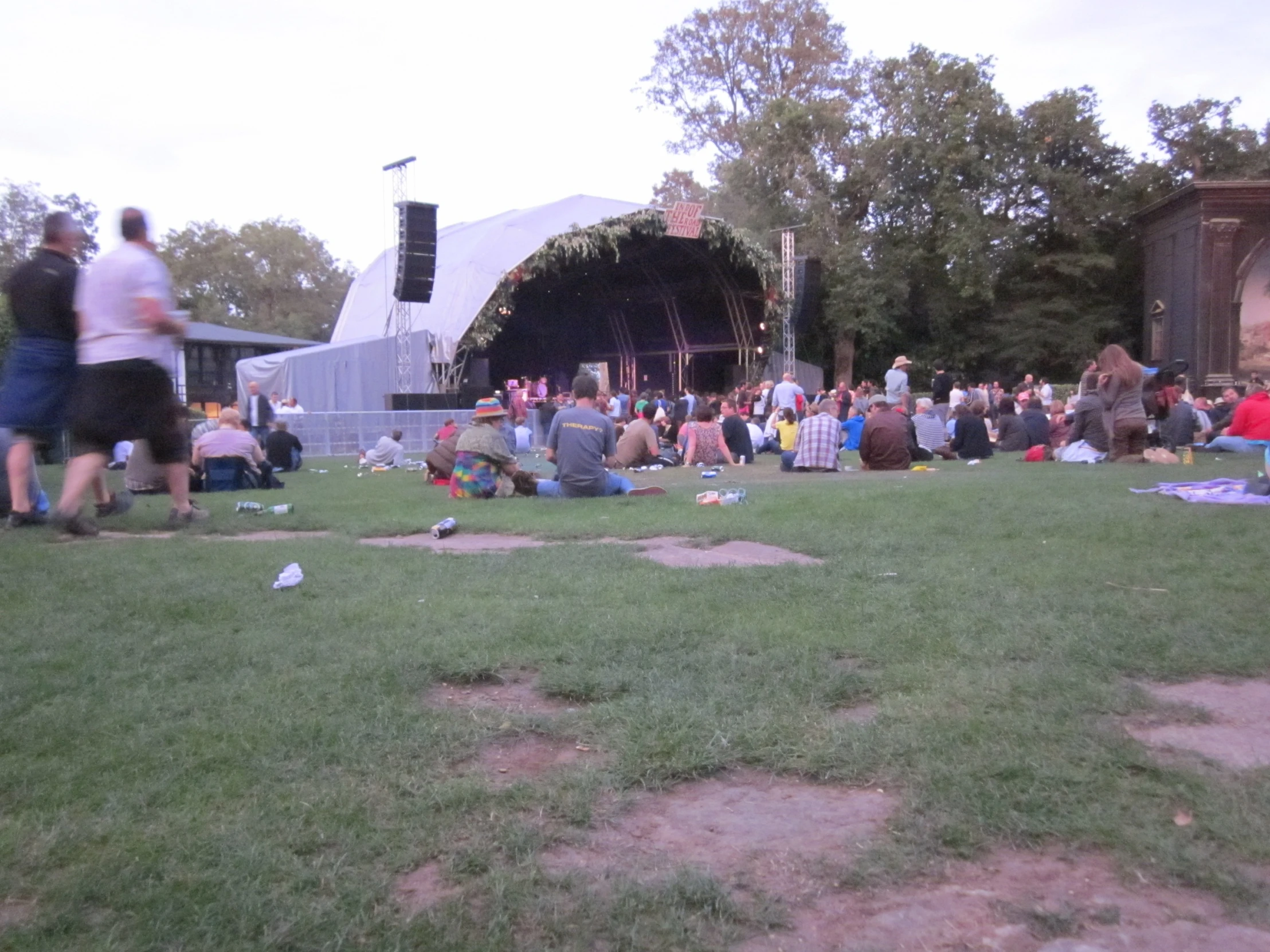 a large group of people sitting in the grass