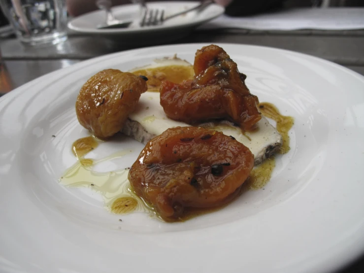 cooked shrimp on top of melted er on white plate