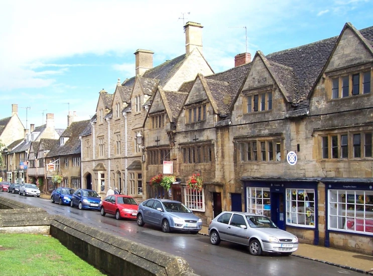 several cars parked in a row on a street