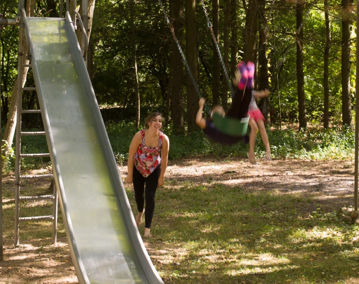 two young people at the same time on a slides