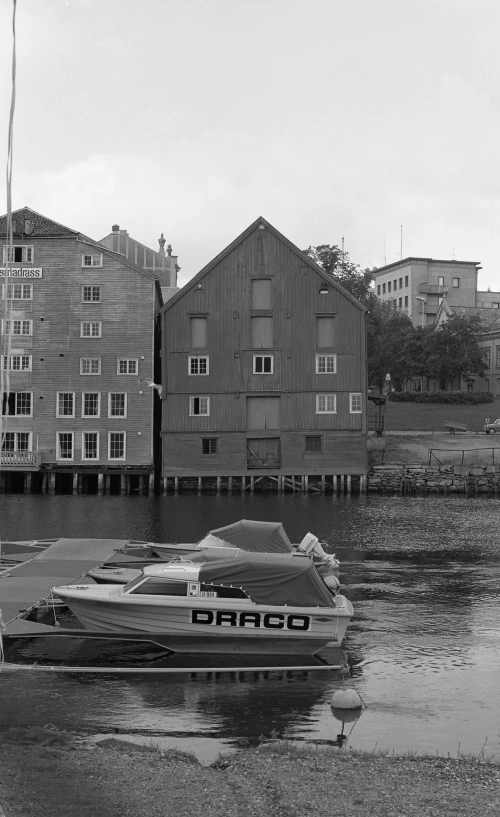 a boat is in the water outside a wooden building