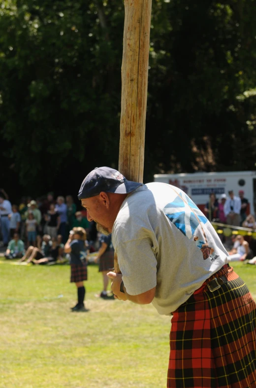 a man with a kilt holding a phone