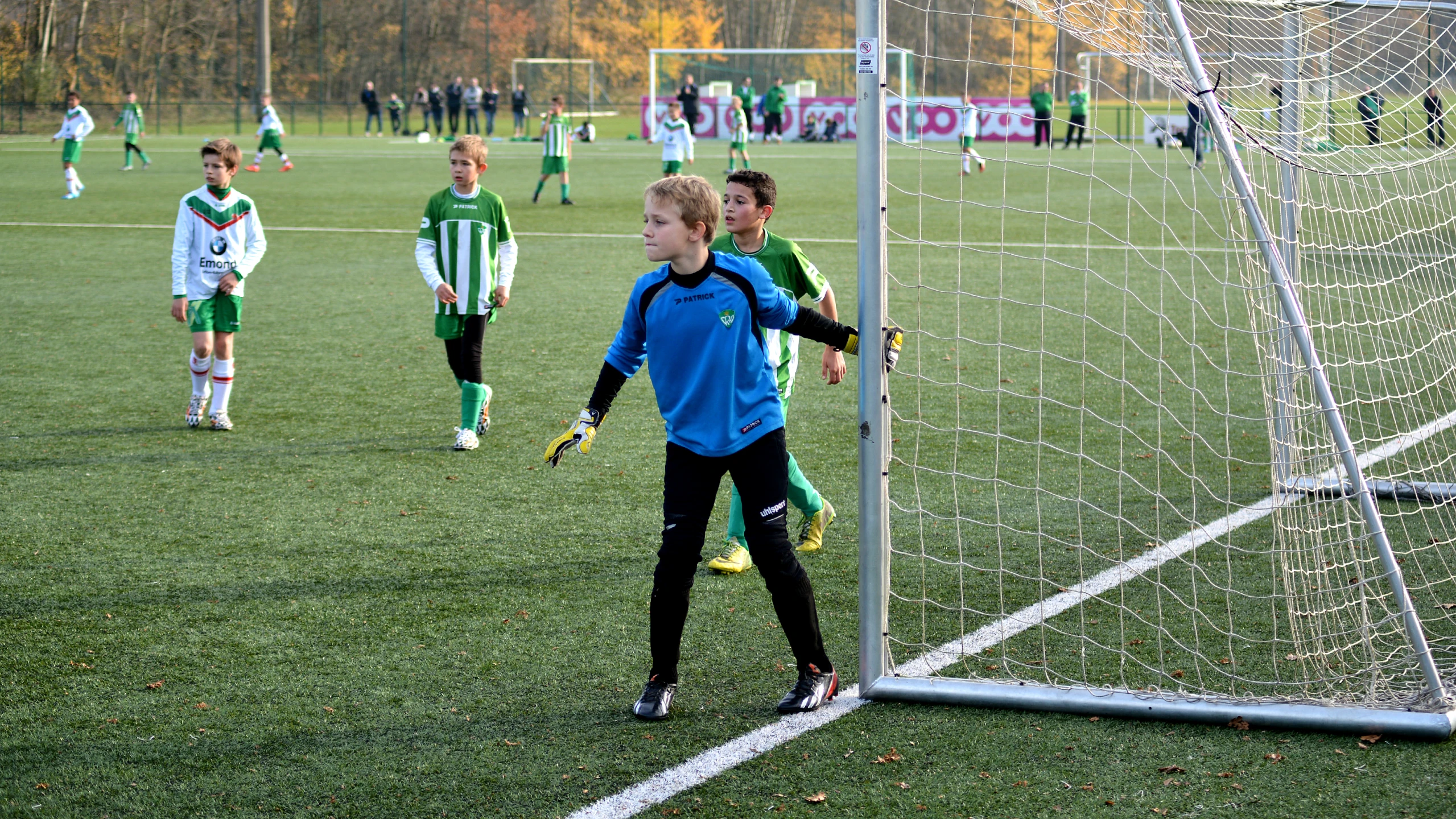 a soccer team at the goal preparing to kick the ball