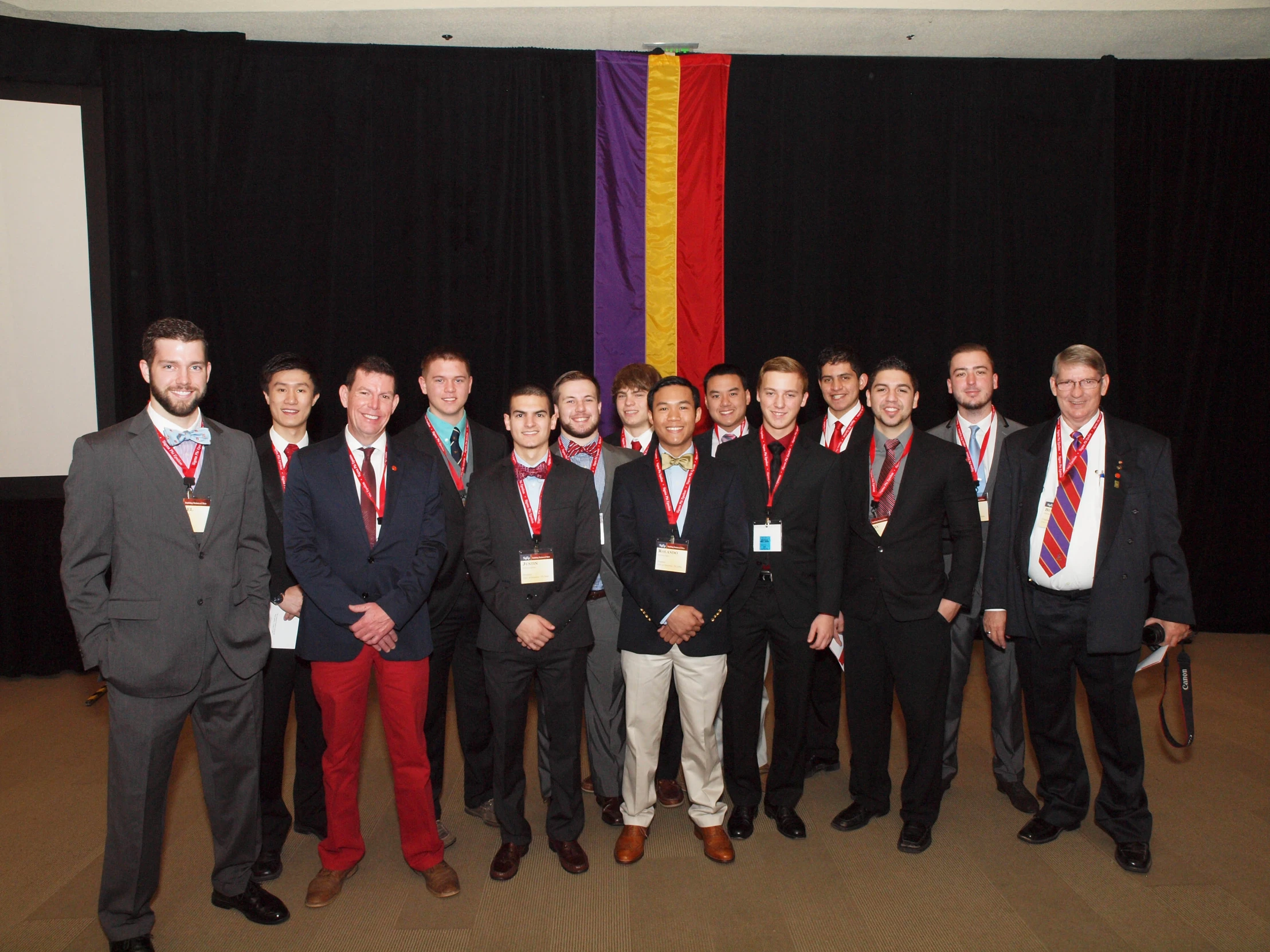 a group of well - dressed men posing for a picture