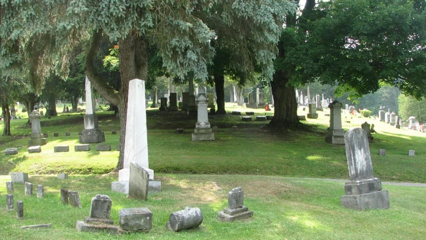 large group of old graves in an empty cemetery