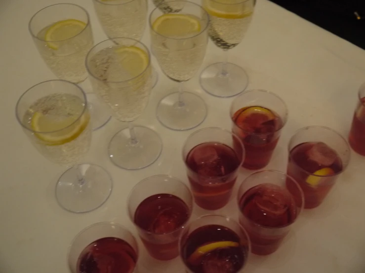 a table with wine glasses that have lemon in them