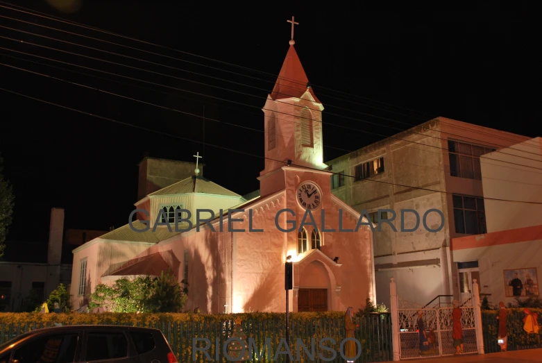 a church is illuminated by an elegantly tall tower